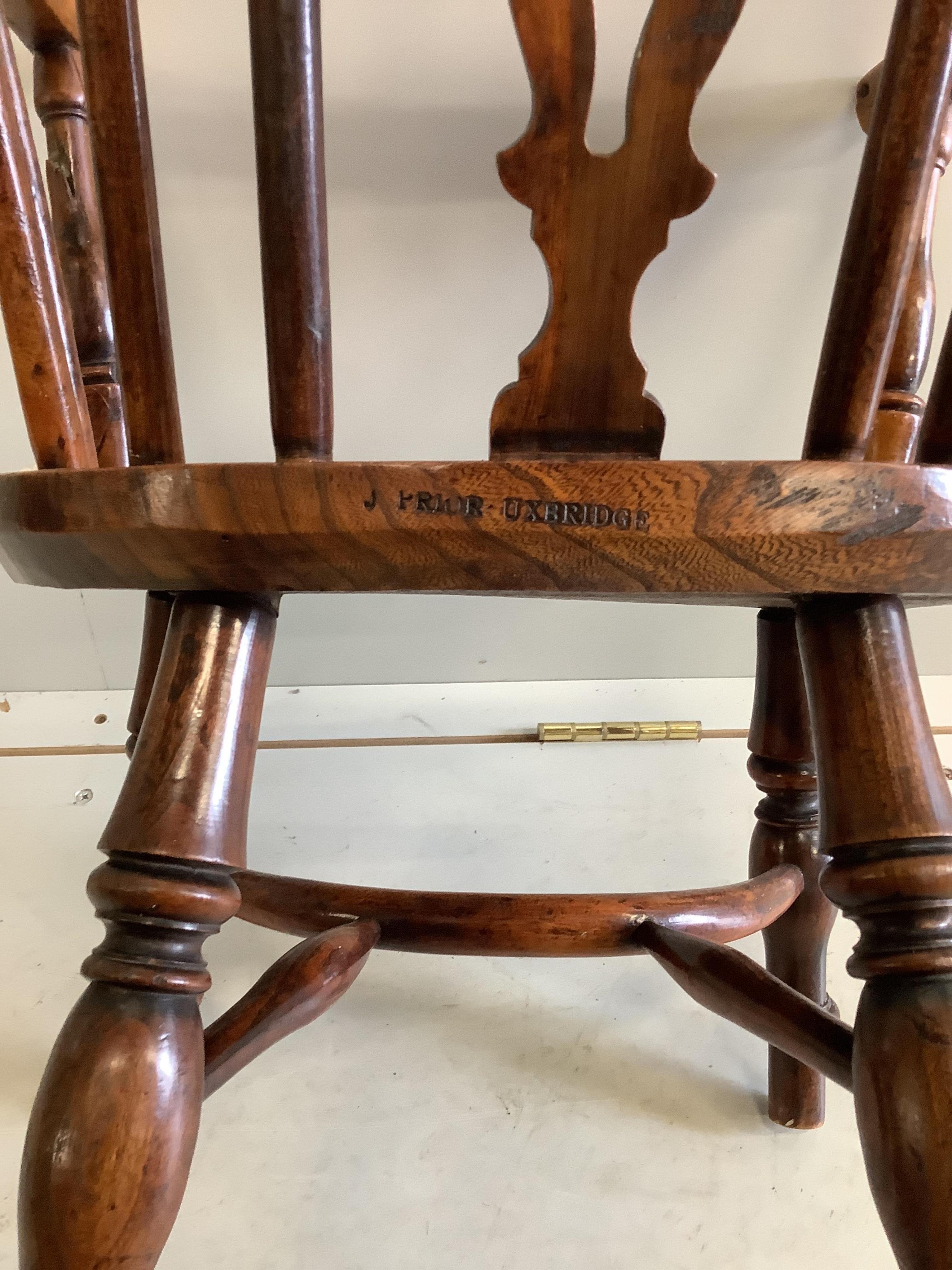 A 19th century yew and elm child's Windsor elbow chair, stamped 'Prior', width 38cm, depth 30cm, height 68cm